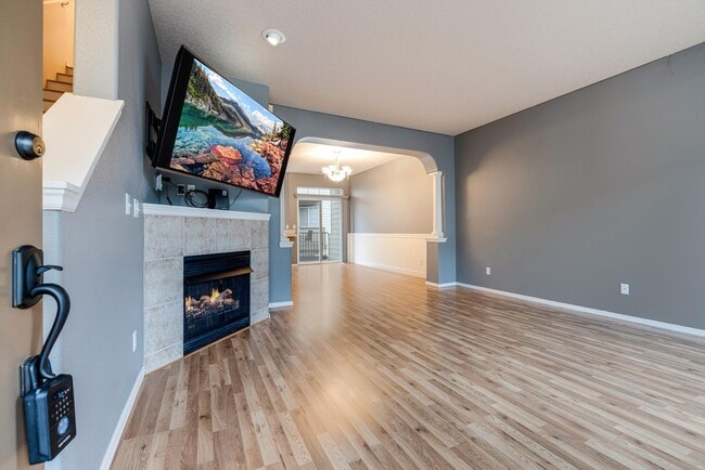 Building Photo - Lovely and bright townhouse with a hard wood flooring throughout, a 2 car garage, AC & more!