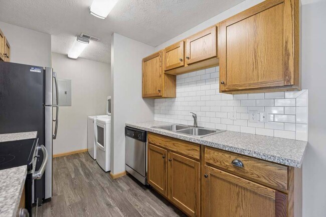 A thoughtfully designed kitchen with updated finishes and ample storage makes every meal feel effortless and inviting. - Williamsburg Park Apartments