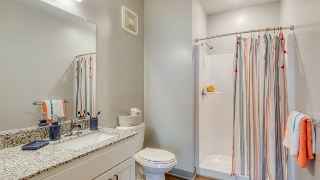 The Arch floor plan features a spa like bathroom with granite countertops, and walk in shower - Ellipse Urban Apartments