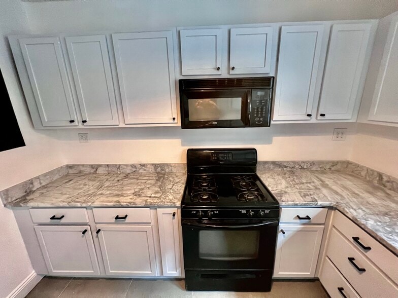 Kitchen with Granite Countertop - 7248 Amherst Ave