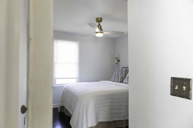 Bedroom doorway looking at queen sized bed. New ceiling fan, bedside sconces - 1217 Landon Ave