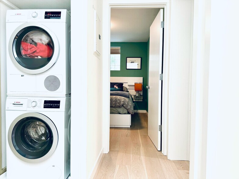 Hideaway stacked Bosch washer and dryer are in a closet in the downstairs hallway - 328 Harriet St