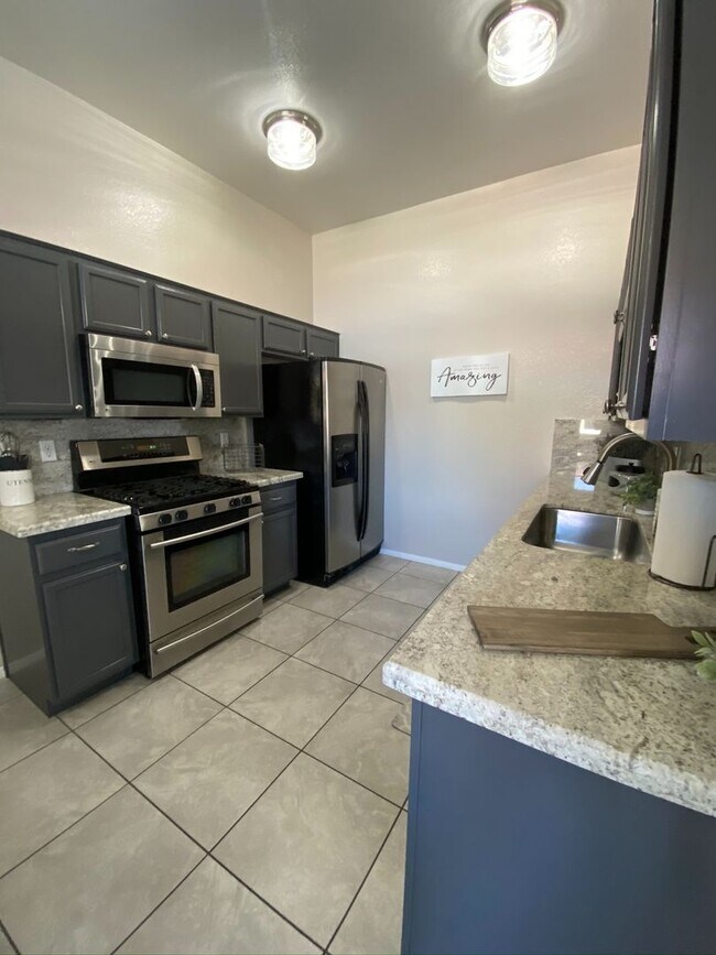 Building Photo - BEAUTIFUL CONDO IN A GATED COMMUNITY FEATURING PLANTATION SHUTTERS, TILE FLOORING AND NEW PAINT T...