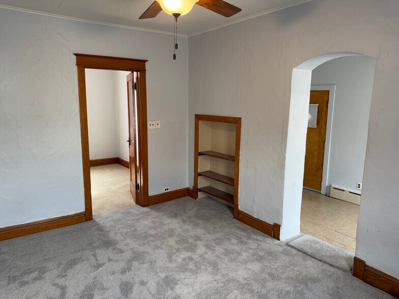Large living room with brand new carpet, hardwood, trim, doorways ,and slelving. - 2346 122nd St