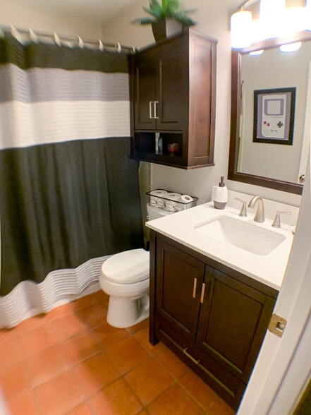 Upscale bathroom next to living room with updated vanity, sink and cabinets. - 2425 Ashdale Dr