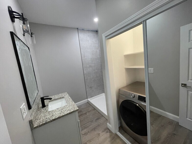 Unit two: bathroom (*brand new sliding glass shower doors have been installed) with laundry space an - 34 Falcon St