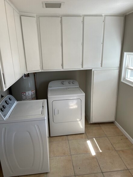 Dedicated laundry room with washer and dryer with tons of storage - 1335 Dallas St