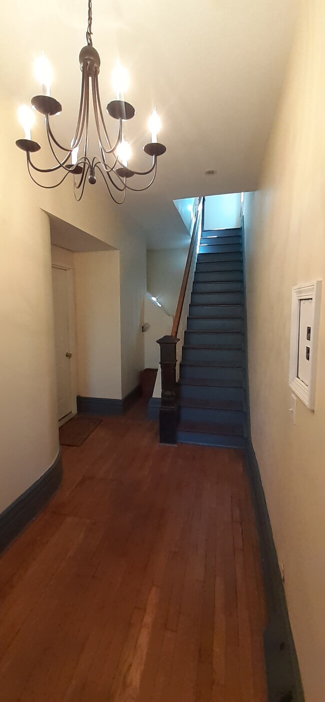 view of stairs from front entry, entry to 1st floor apartment on left - 7718 Brashear St