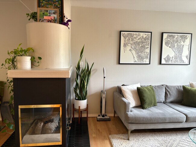 Gas fireplace separating living room and dining room - 6337 Hillman Pl NE