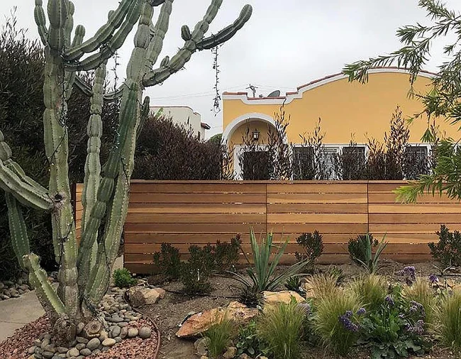 Front of building showing gated private yard. There is also a gated side yard at left. - 1443 Centinela Ave