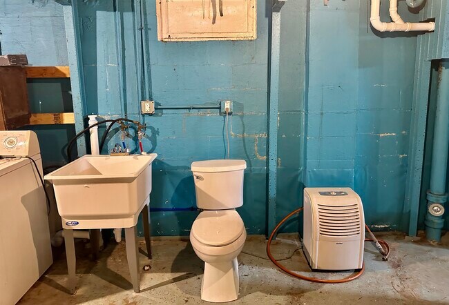 Laundry area with sink and toilet - 1444 Dodge St