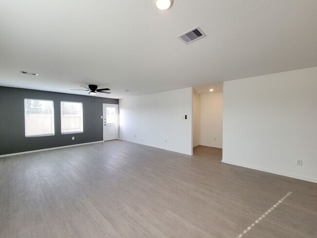 Building Photo - This single-level home showcases a spacious open floorplan shared between the kitchen, dining are...