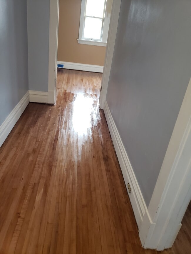Hallwayfrom Bathroom facing Bedroom 1: Floors completely refinished and fresh paint. - 522 N 42nd Ave W
