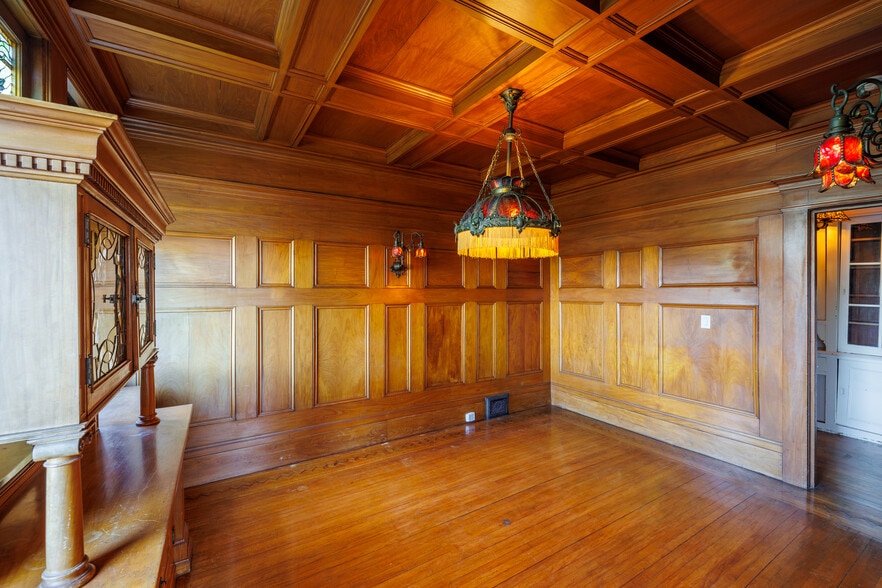 fully paneled wood room w/red glass sconces & chandelier - 2398 Broadway