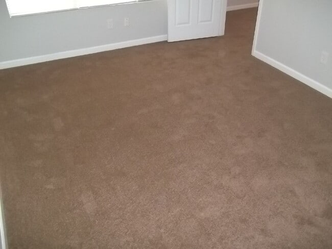 Building Photo - Freshly painted and new flooring in this 4 Bedroom 2 and Half Bath home. Covered front porch with...