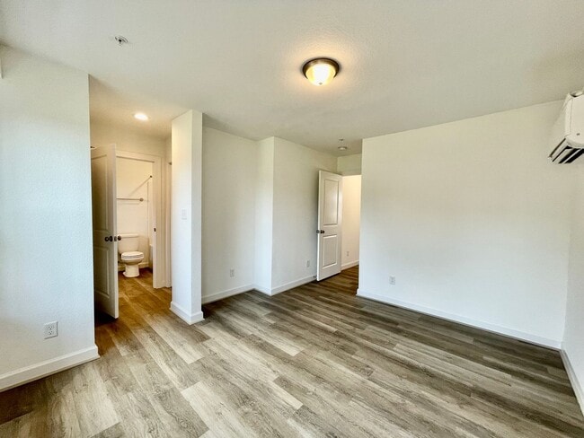 Building Photo - Practically New & Available NOW! Americana Luxury Townhomes! Pet Friendly! Attached Garage! All A...