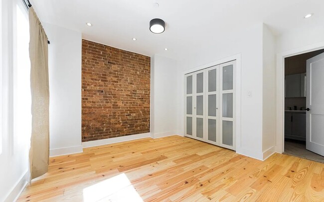 Bedroom 1, brick feature wall (front) - 1419 Pacific St