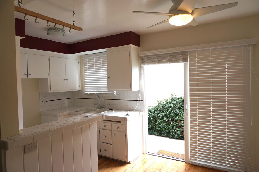 Newly tiled kitchen with stove and large sliding glass doors - 14333 Albers St