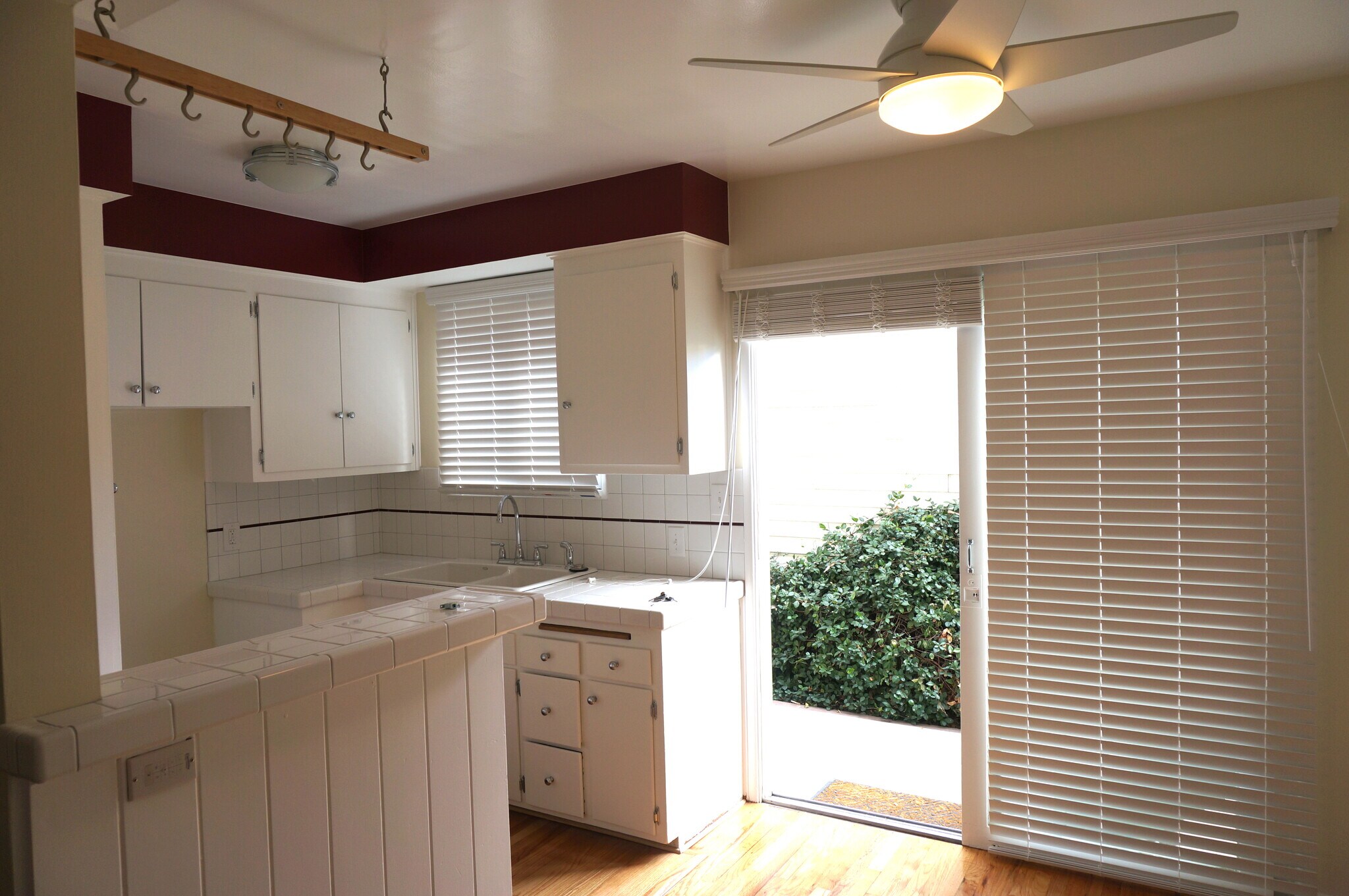 Newly tiled kitchen with stove and large sliding glass doors - 14333 Albers St