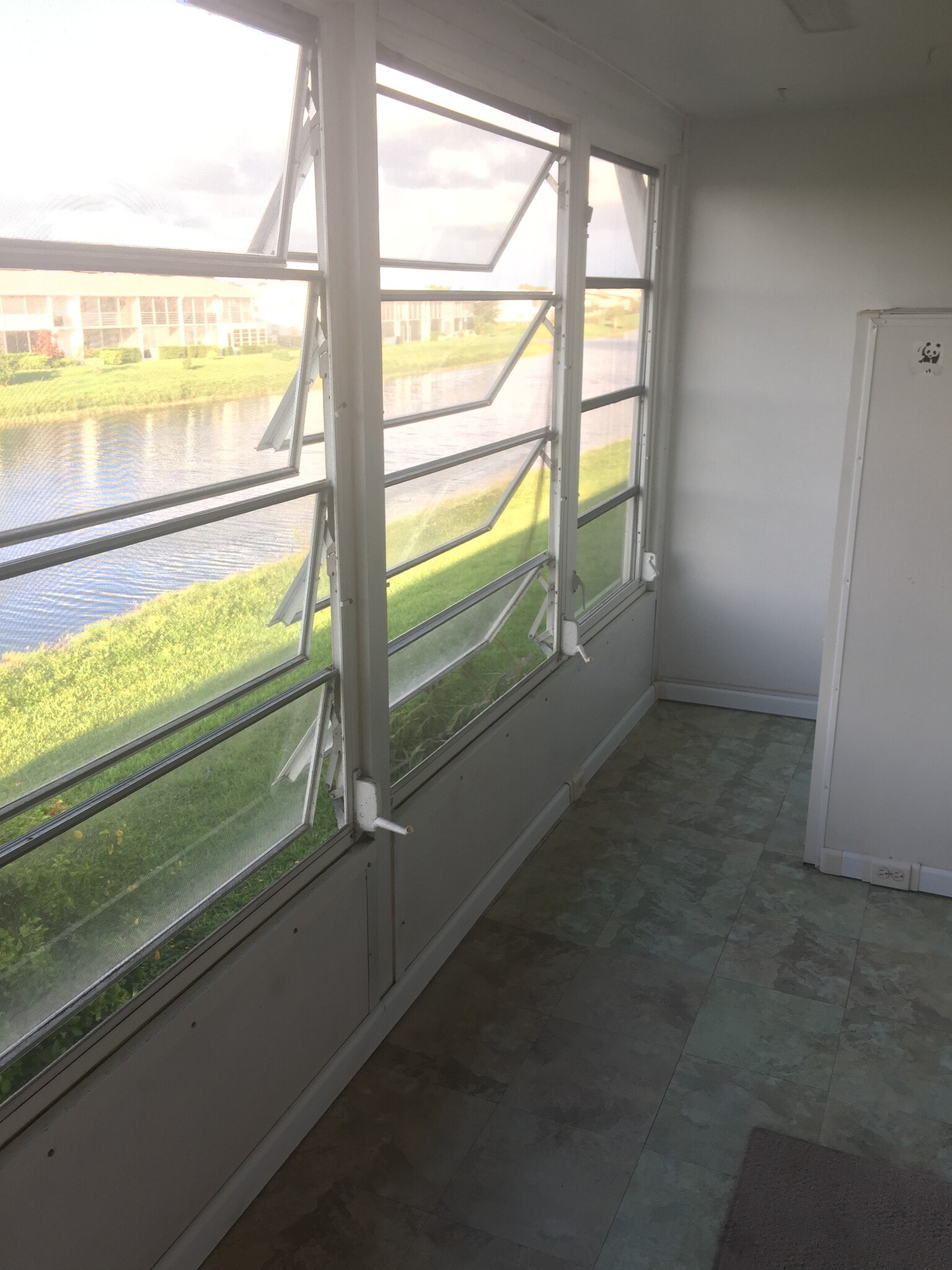 This wide patio gives you a generous view of the water . The screened windows allow you to enjoy this view all year long. A large storage cabinet can be found at the end of the patio. This is truly yet another living space in this beautiful condo! - 91 Berkshire D