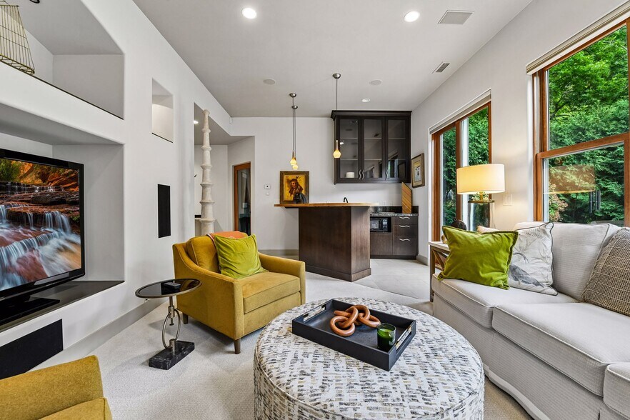 The lower level offers entertaining space, a wet bar, exercise room, and access to the walkout patio - 745 Rice St E