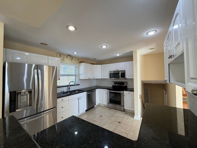 Building Photo - Freshly Painted Split-Level Home with Large Deck & Lawn Care Included