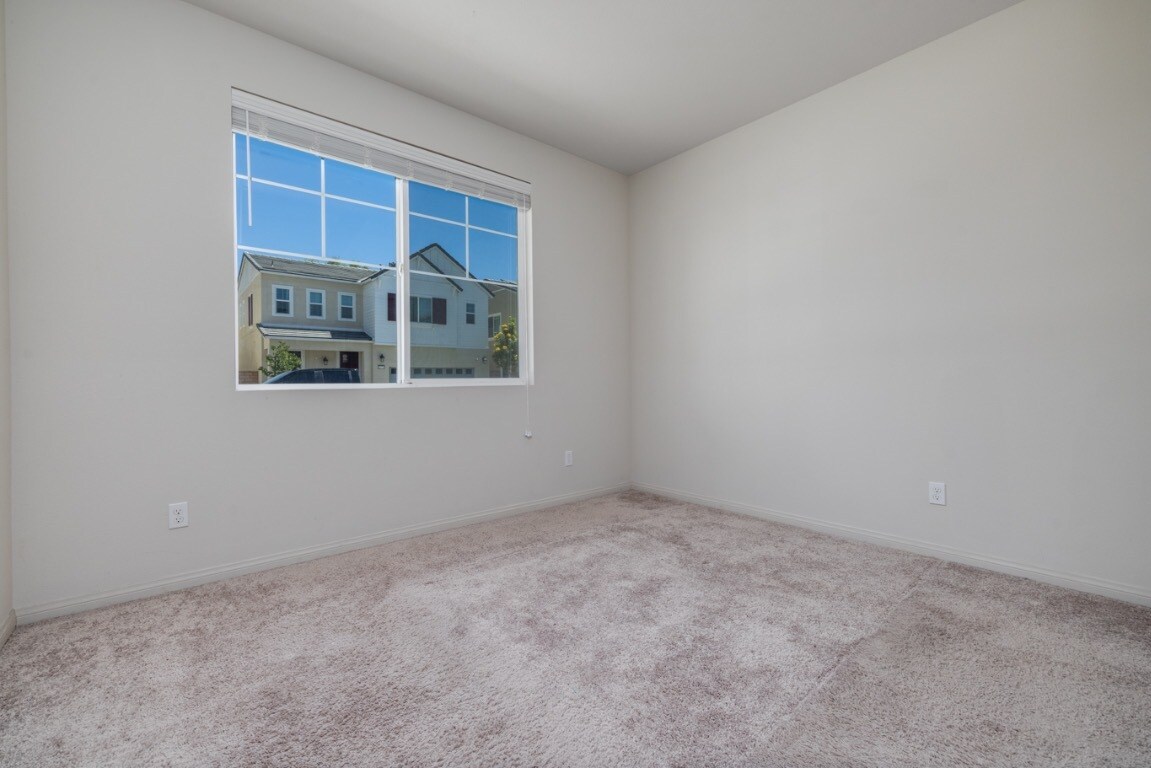 Another angle of the upstairs bedroom showcasing how abundant natural light fills - 26549 Brightstone Dr