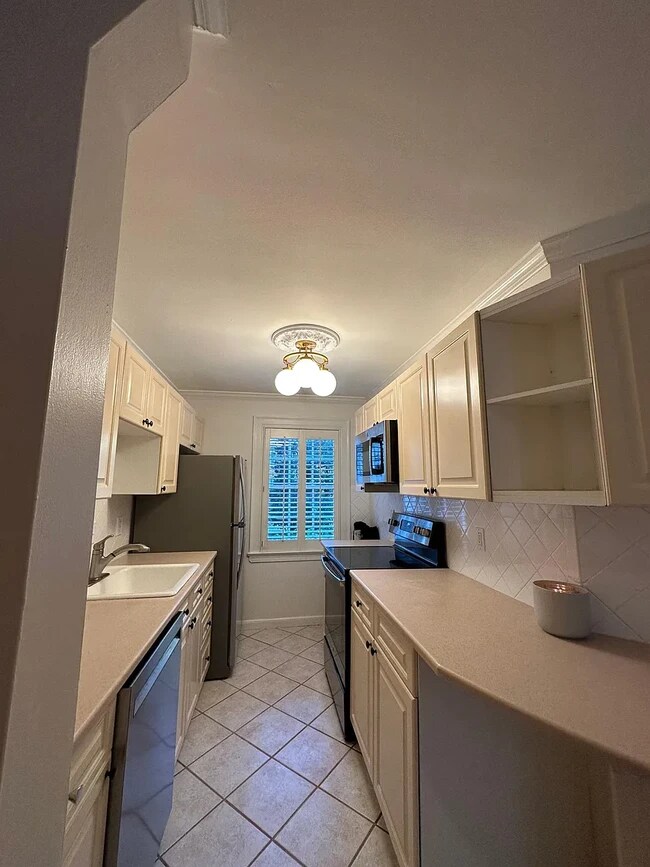stunning white kitchen with plenty of storage and refreshed with Italian lighting - 108 Colville Rd