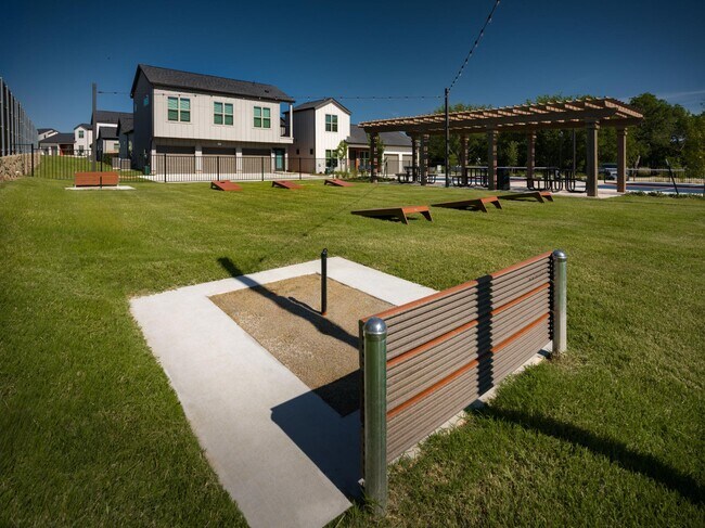 outdoor game area with horseshoe, cornhole, and pickeball - parcHAUS at Paloma Creek