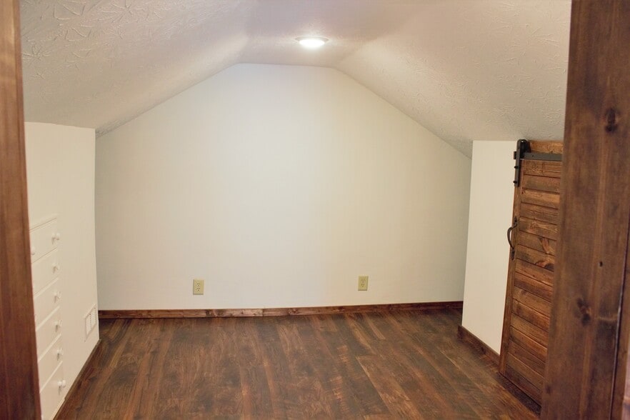 Second bedroom in upper level - newer everything just as the first one; built-in dresser, sliding barn door to closet. - 9331C Tallmadge Road