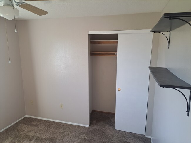Center bedroom with mounted shelving - 15815 NE 69th St