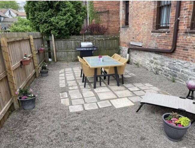 Shared patio space with grill, table and garden - 65 Whitney Plz