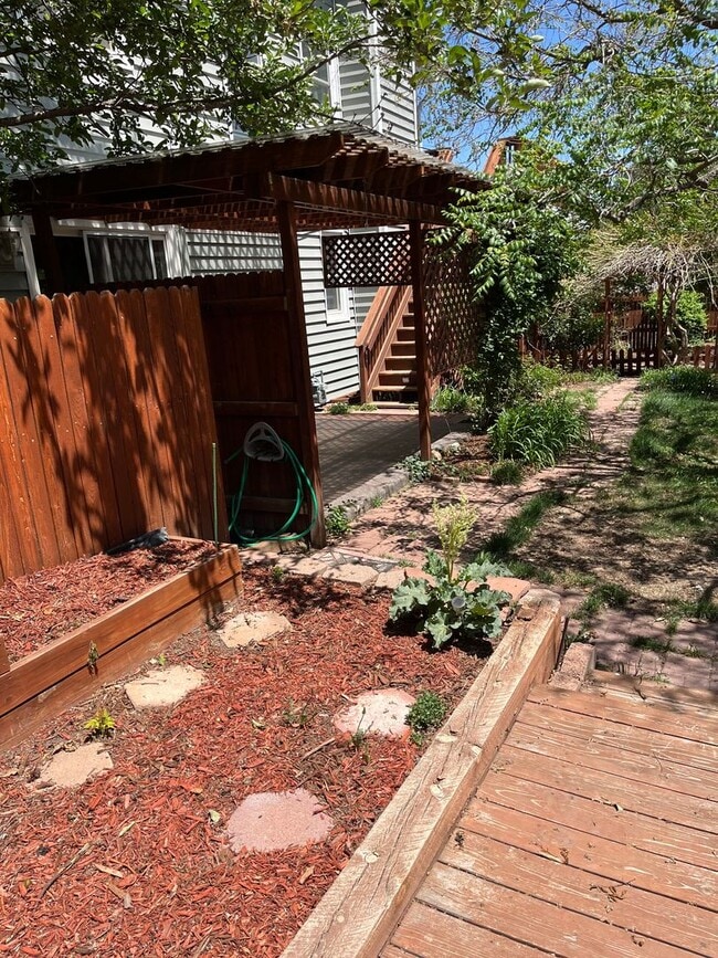 Building Photo - 4 Bedroom Gardener's Delight With Rooftop Patio, Privacy and Covered Parking