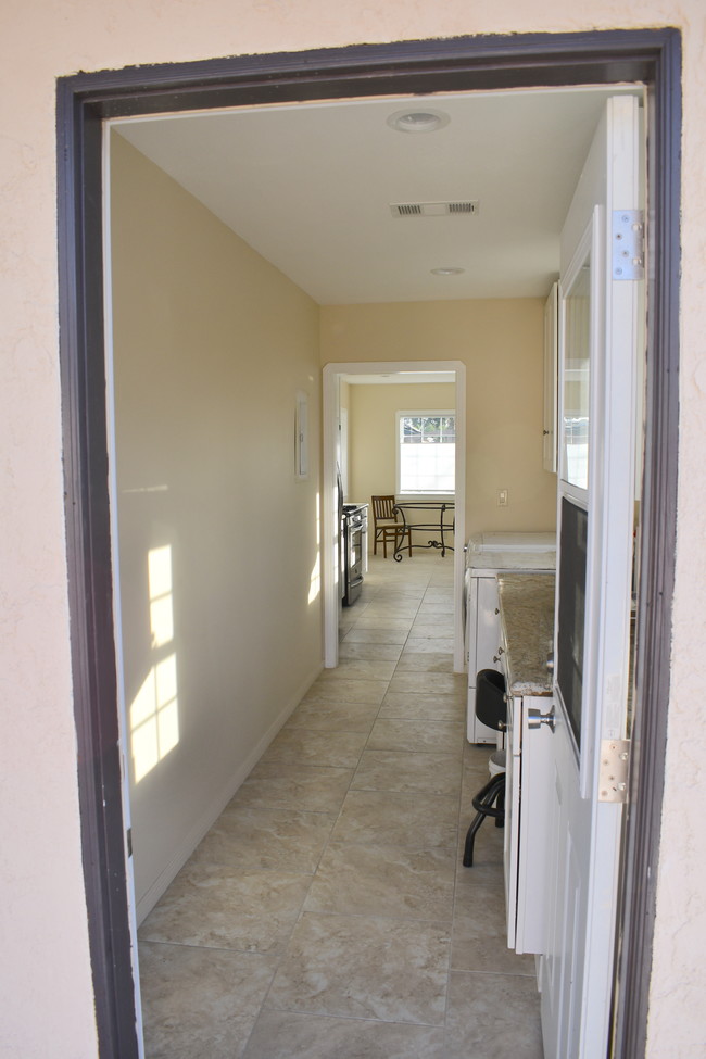 Laundry room looking into kitchen - 6155 W 75th Pl