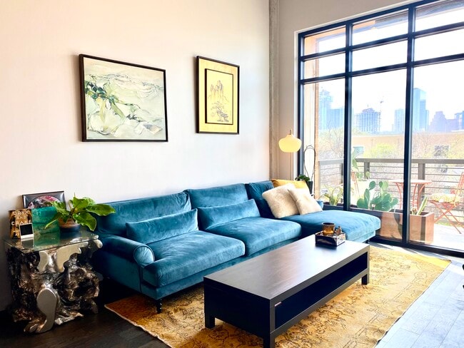 A spacious custom sofa defines the living area. - 1501 E 4th St