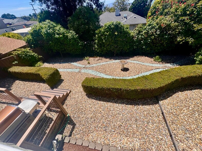 The rear garden is anchored by a traditional birdbath and two-tone low maintenance dry creek bed des - 2403 Mira Vista Dr