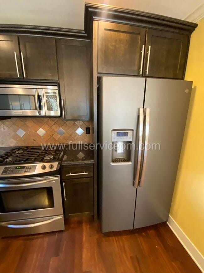 Building Photo - Spacious townhome with private backyard, garage parking, multiple decks, and a dedicated home off...