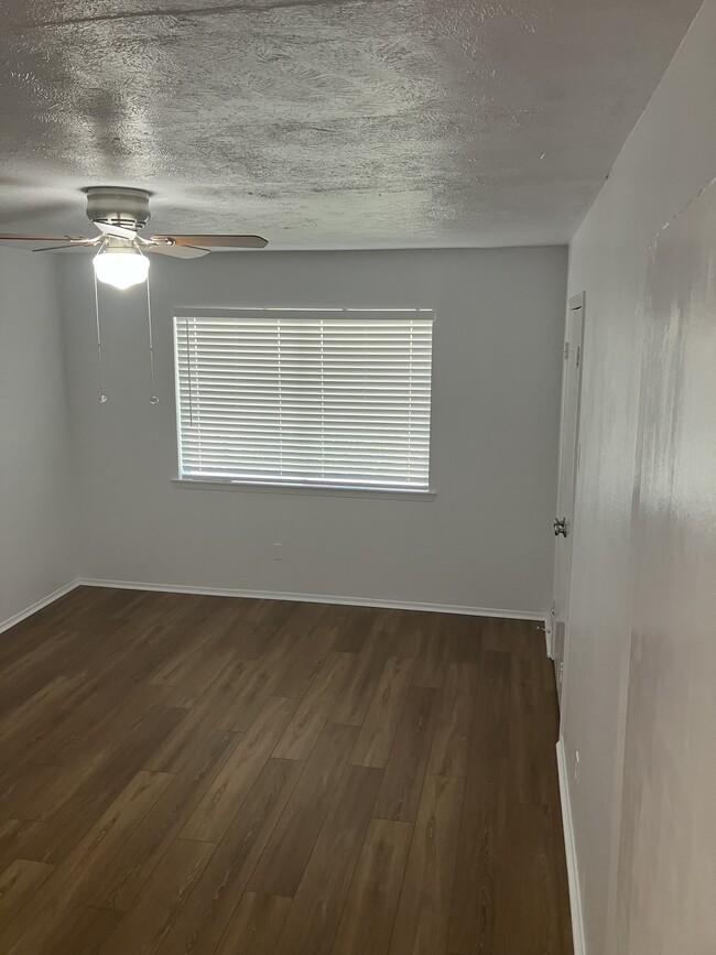 The first bedroom with new laminate flooring. - 13559 Red Fern Ln