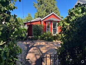 Building Photo - Charming Red Cottage with Lush Garden Spac...