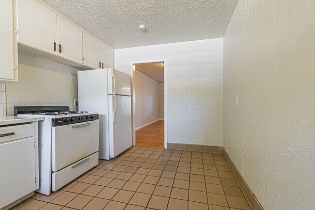 Building Photo - Three Bedroom Home in tree filled neighborhood! Lawn care included!
