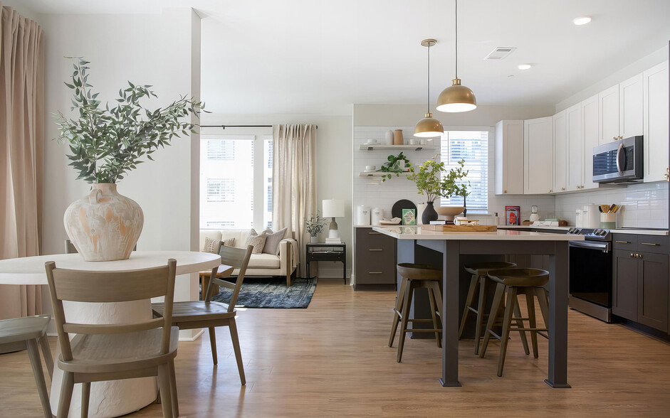 Picturesque open kitchen area with modern island and charcoal color cabinets - Novel Cary