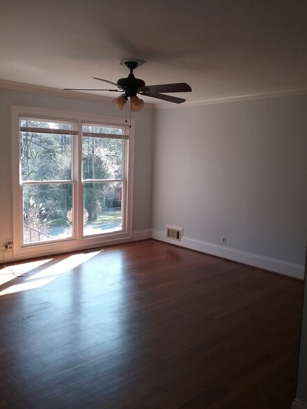 Hardwoods throughout and large windows to bring in natural light - 701 Rosalyn Dr