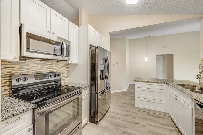 Building Photo - Spacious 3/2 with split plan and large fenced yard!