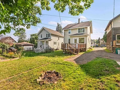 Back of house with deck and driveway - 922 N 14th Ave E