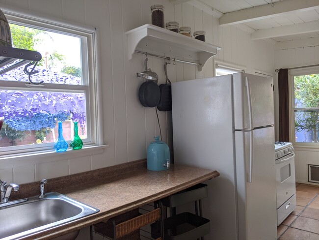 kitchen counter/garbage disposal/full sized fridge/stove. All utilities included in rent - 3771 Boise Ave