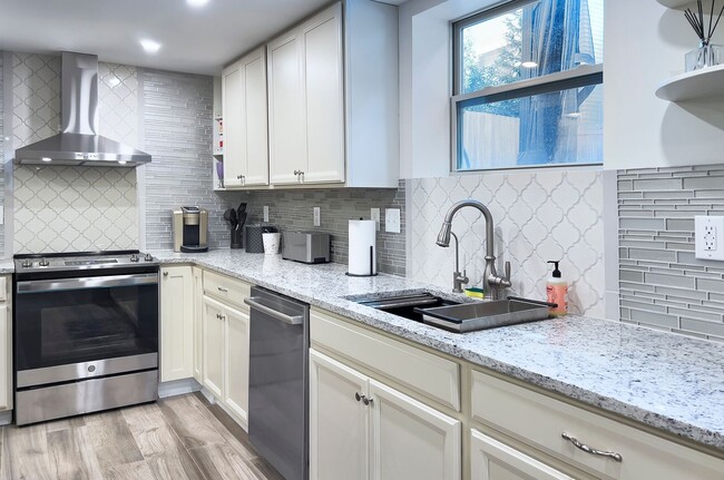Building Photo - Discover the charm of this FULLY FURNISHED basement unit, tucked away in a beautifully updated bu...