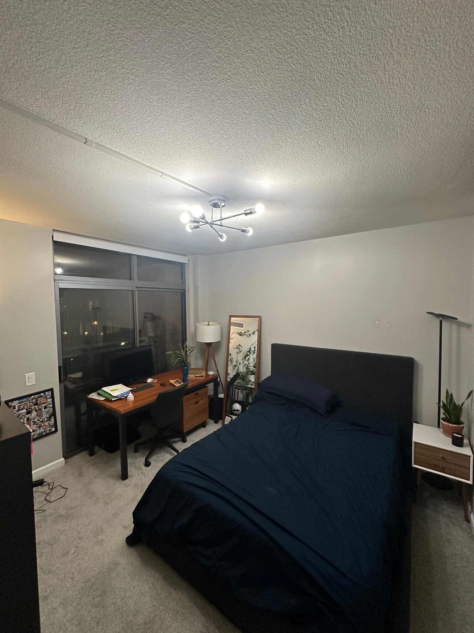 Primary bedroom from entryway. Can see the window and sliding door to the primary balcony. - 440 L St NW