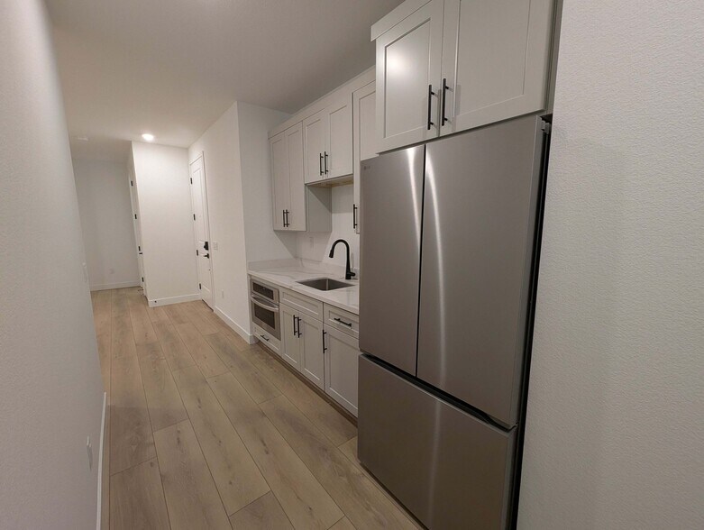 Kitchenette with new stainless steel appliances and quartz countertop - 628 S Cecita Wy