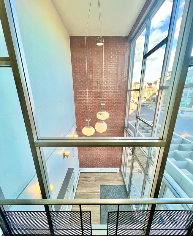 Experience urban elegance with this loft's expansive windows and contemporary design elements. - Harmony Apartments