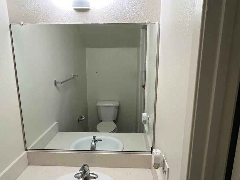 Downstairs Half Bath Powder room with newer vanity top and plumbing - 1103 W Francis St
